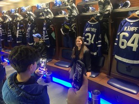 Fans take in the Maple Leafs locker room during a tour of Scotiabank Arena.
