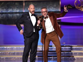 Evan Goldberg and Seth Rogen accept an award.
