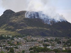 View of flames and smoke from a fire on Arthur's Seat in Holyrood Park, Edinburgh, Scotland, Sunday Aug. 10, 2025.