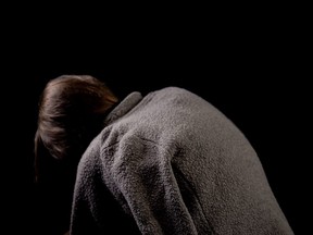 Hunchback beggar on black background, spinal diseases in old age, kyphosis