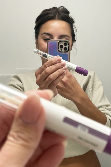Antoinette Twiver, then 28, snaps a selfie of herself with her first hormonal shot for egg freezing.