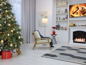 Beautiful tree with festive lights and Christmas decor in living room. Interior design