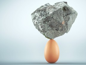 Rock standing on egg. Unstoppable and strong idea concept. This is a 3d render illustration