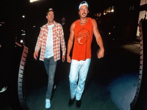Country music star Morgan Wallen, right, and Edmonton Oilers captain Connor McDavid, walk out to a sold-out crowd at Commonwealth Stadium in Edmonton