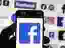 The Facebook logo is seen on a cellphone.