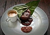 Molten chocolate cake wrapped in cacao leaf, with cacao pulp jam and espresso. PHOTO BY ADAM WAXMAN/DINE MAGAZINE