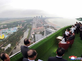 In this photo provided by the North Korean government, North Korean leader Kim Jong Un, sitting centre, with his wife Ri Sol Ju, rear, and daughter tours the Wonsan-Kalma coastal tourist zone in North Korea Tuesday, June 24, 2025.