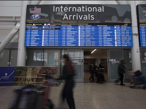 Travellers tote their luggage at Pearson airport.