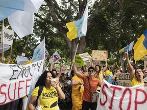 People march during a mass demonstration against overtourism, which affects the local population with inaccessible housing, among other things, in Santa Cruz de Tenerife, Spain, April 20, 2024. (AP Photo/Miguel Velasco Almendral)