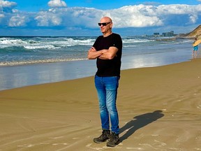 A bald man in blue jean
