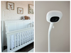 The Nanit Pro baby monitor set up in a nursery with a white crib