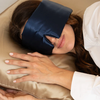 woman wears Emily's Pillow Deep Sleep SILK EYE Mask