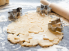 Making homemade Christmas cookies.The dough and shape on a dark background