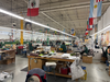 A general shot of the factory that features flags of the countries where workers originated.