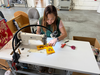 Seamstress making a smiley face patch.