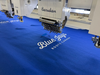 A machine stitching the Toronto Blue Jays logo.